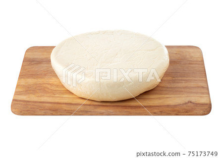 Cheese on a wooden board. Close Up piece of cheese on a white background. 75173749