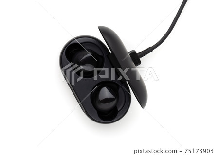 Wireless headphones on a white background. Headset close up in the charging case close-up. 75173903