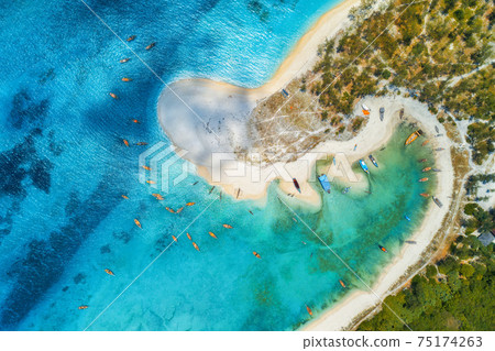 Aerial view of the fishing boats on sea coast with sandy beach Aerial view of the fishing boats on sea coast with sandy beach 75174263