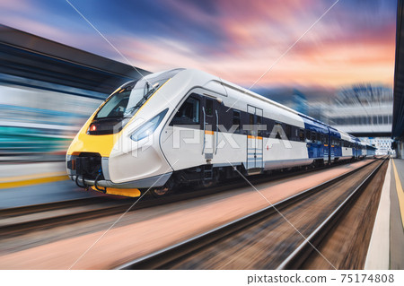 High speed train in motion on the railway station at sunset 75174808