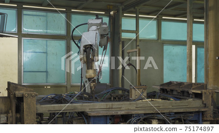 Steel smart robot welding hand system automated manufacturing machine engine in factory, industry metal supply chain technology production equipment in operation process warehouse. Welding sparks. Steel smart robot welding hand system automated manufacturing machine engine in factory, industry metal supply chain technology production equipment in operation process warehouse. Welding sparks. 75174897