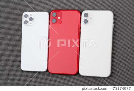 Three smartphones on a gray background. 75174977