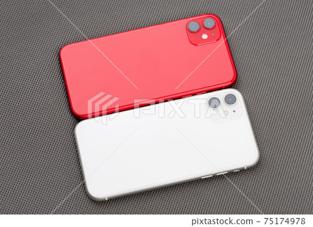 Two smartphones on a gray background. Two smartphones on a gray background. 75174978