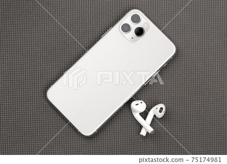 Smartphone on a gray surface. A popular smartphone close-up. Smartphone on a gray surface. A popular smartphone close-up. 75174981