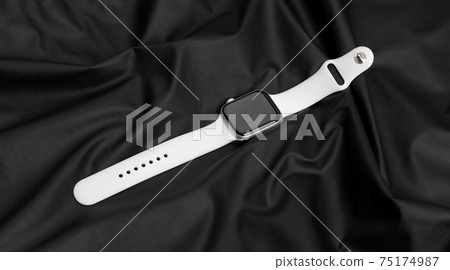 Smart Watch on a black leather surface. 75174987