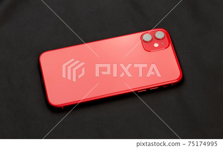 Smartphone with three cameras on black leather fabric. Smartphone with three cameras on black leather fabric. 75174995