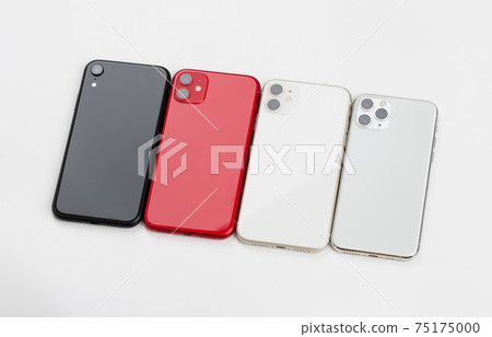 Four smartphones of different colors close-up on a white background. Four smartphones of different colors close-up on a white background. 75175000
