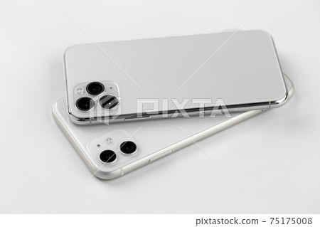 Two smartphones close-up on a white background. 75175008