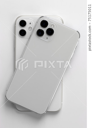 Two smartphones close-up on a white background. Two smartphones close-up on a white background. 75175011