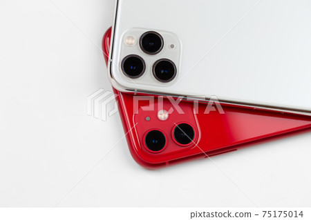 Two smartphones close-up on a white background. Two smartphones close-up on a white background. 75175014