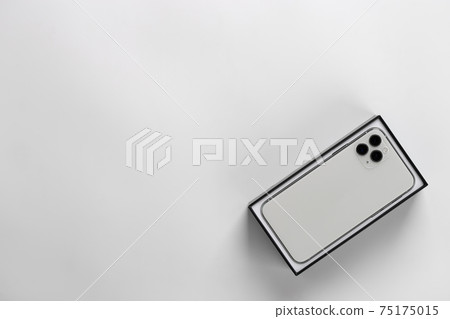 Smartphone in box close-up on a white background. Smartphone in box close-up on a white background. 75175015