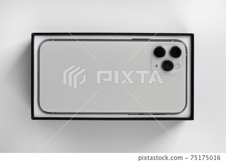 Smartphone in box close-up on a white background. Smartphone in box close-up on a white background. 75175016