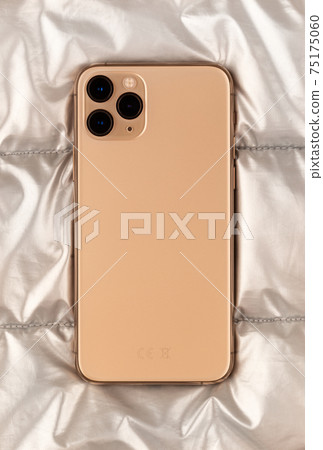 Smartphone on a silver cloth. A popular smartphone close-up. Smartphone on a silver cloth. A popular smartphone close-up. 75175060