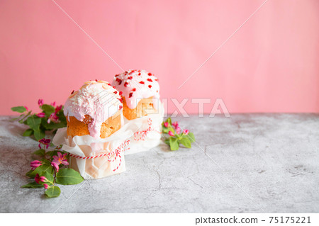 Traditional Easter bread or cake, decorated with sugar decor icing and berries on grey background. Happy Easter Holidays. Copy space. 75175221