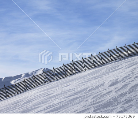 Snowy ski track prepared by snowcat with trace from skis and snowboards Snowy ski track prepared by snowcat with trace from skis and snowboards 75175369