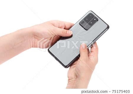 Smartphone with a broken back cover in hands on a white background. 75175403