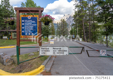 Signboard of Lake Minnewanka. Famous tourist attraction for leisure activities, boat cruise and mountain trail hiking in Banff National Park, Canadian Rockies. Signboard of Lake Minnewanka. Famous tourist attraction for leisure activities, boat cruise and mountain trail hiking in Banff National Park, Canadian Rockies. 75175411