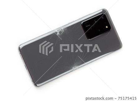 Smartphone with a broken back cover on a white background. Smartphone with a broken back cover on a white background. 75175415