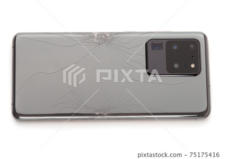 Smartphone with a broken back cover on a white background. 75175416