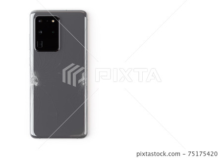 Smartphone with a broken back cover on a white background. Smartphone with a broken back cover on a white background. 75175420