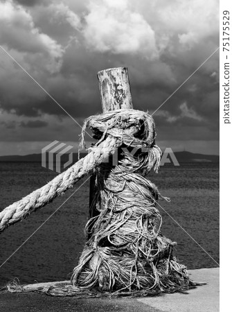 Rope on seafront, sea and beautiful cloudy sky in sunny summer day 75175529