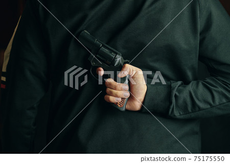 A man with a revolver on his back. A man with a revolver on his back. 75175550