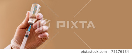 Nurse holding syringe and vaccine against covid Nurse holding syringe and vaccine against covid 75176184