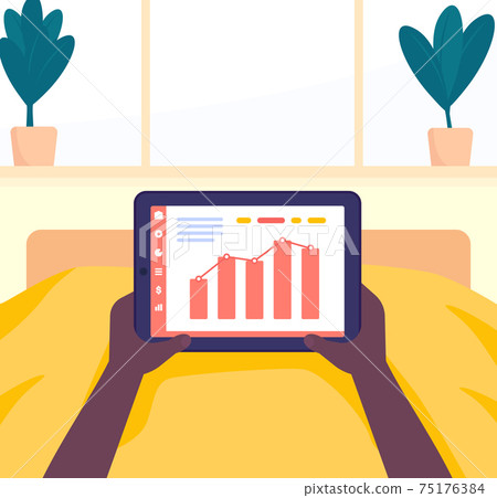working at home in bed with tablet in hands 75176384
