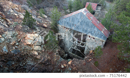 Old broken lift over abandoned vertical mine shaft, aerial view 75176442