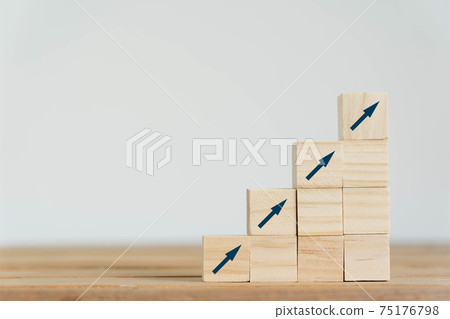 On table arrow go up on wood block stacking same as step stair background, Business growth up concept. copy space for text. Abstract Success stock market . management achievement. copy space 75176798