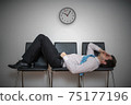 Tired bored man is sleeping in waiting room on chairs. 75177196