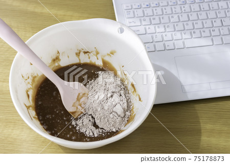 Image of making chocolate sweets by looking at a laptop 75178873