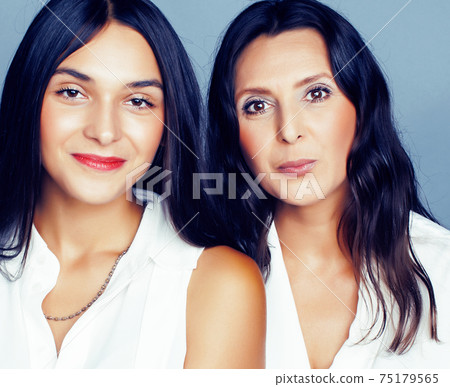 cute pretty teen daughter with mature mother hugging, fashion style brunette, lifestyle people concept 75179565