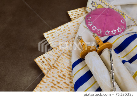 Orthodox Jewish prepared with Torah Scrolls kosher matzah on traditional pesach jewish passover holiday Orthodox Jewish prepared with Torah Scrolls kosher matzah on traditional pesach jewish passover holiday 75180353