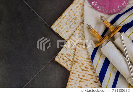 Pesach Israeli matzah bread for the Jewish holiday with torah scroll 75180623
