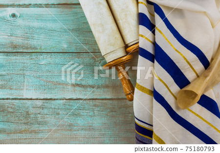 Jewish holidays, during prayer items kippa with prayer shawl tallit on shofar, torah scroll 75180793