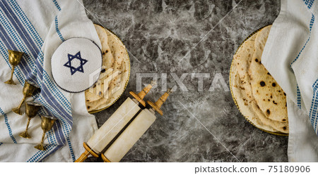 Orthodox Jewish family symbols with cup wine kosher matzah on traditional jewish passover holiday Scrolls torah Orthodox Jewish family symbols with cup wine kosher matzah on traditional jewish passover holiday Scrolls torah 75180906