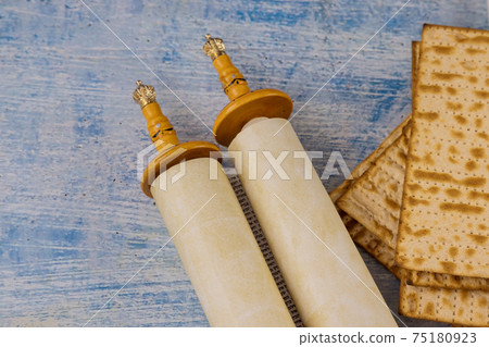 Pesach Jewish celebration with Torah Scrolls, kosher matzah on traditional jewish passover holiday 75180923