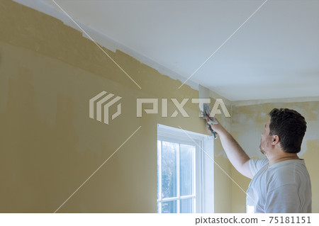 Plastering wall coating putty plaster on the wall Plastering wall coating putty plaster on the wall 75181151