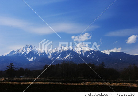 Yatsugatake with the remaining snow from Yatsugatake Ranch in Hokuto City, Yamanashi Prefecture in early spring 75183136