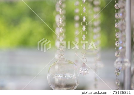 Wedding festive outdoor background - Bokeh effect and camera lens flares. Glass pearls and metal decoration. White colors, shiny 75186831