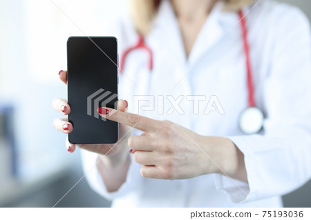 Doctor pressing his finger on screen of mobile phone closeup Doctor pressing his finger on screen of mobile phone closeup 75193036