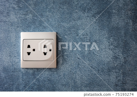 electrical socket on blue wall, power supply 75193274