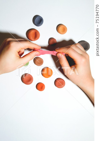 Child's hands close-up with plasticine. Child's hands close-up with plasticine. 75194770