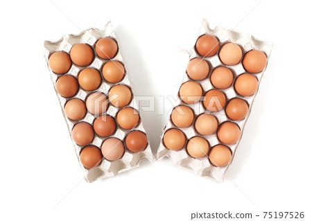 Eggs of chicken in paper tray on white background. Top view. Eggs of chicken in paper tray on white background. Top view. 75197526