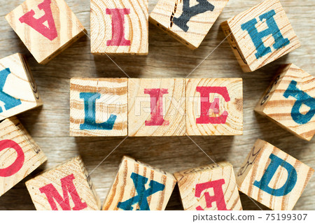 Alphabet letter block in word lie with another on wood background Alphabet letter block in word lie with another on wood background 75199307