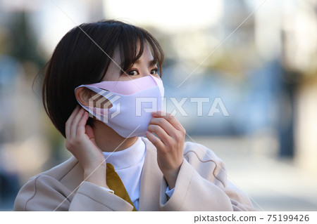 A woman who wears masks A woman who wears masks 75199426