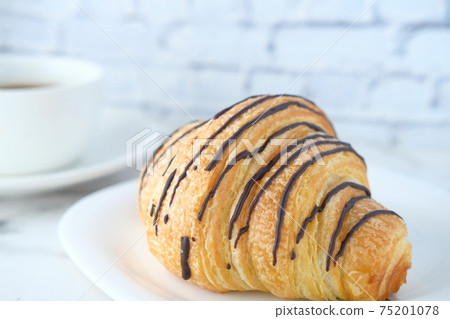 fresh baked croissant on plate with copy space fresh baked croissant on plate with copy space 75201078