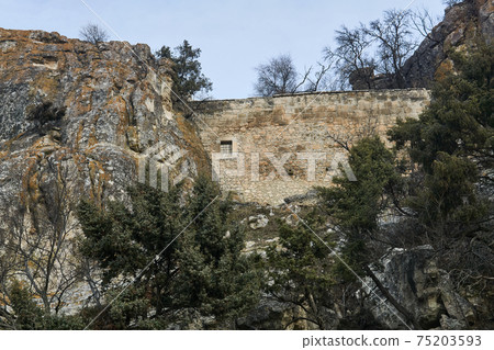 view of the ruins of an ancient ancient fortress wall between the rocks view of the ruins of an ancient ancient fortress wall between the rocks 75203593