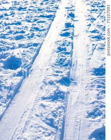 ski track lit by sun close up on frozen river ski track lit by sun close up on frozen river 75207093